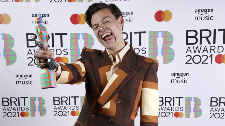 Harry Styles posing with Brit Award