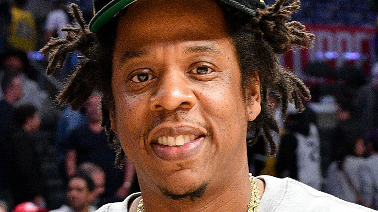 Jay-Z smiling at a basketball game