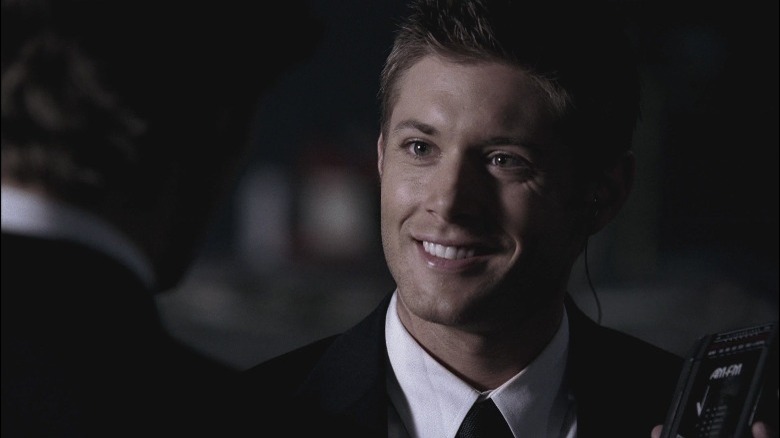 Jensen Ackles smiling while speaking to someone