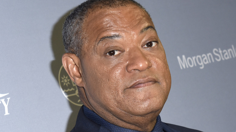 Laurence Fishburne wearing a blue shirt and jacket