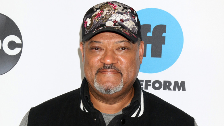 Laurence Fishburne on the red carpet in a hat