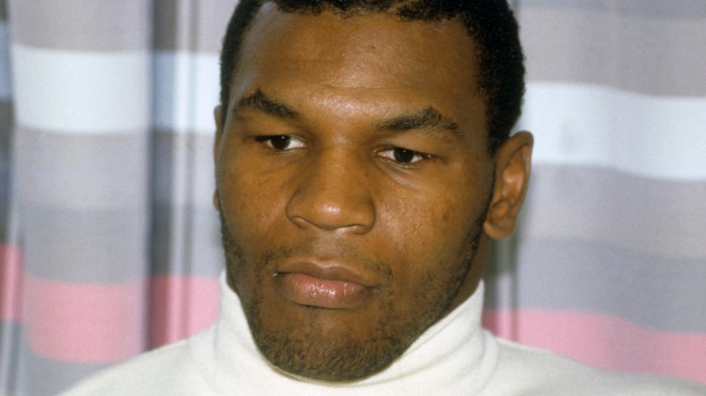 Mike Tyson wearing a white turtle neck