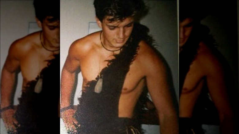 Nathan Fillion posing in Tarzan outfit