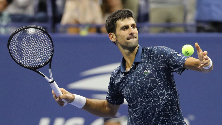 Novak Djokovic playing tennis 