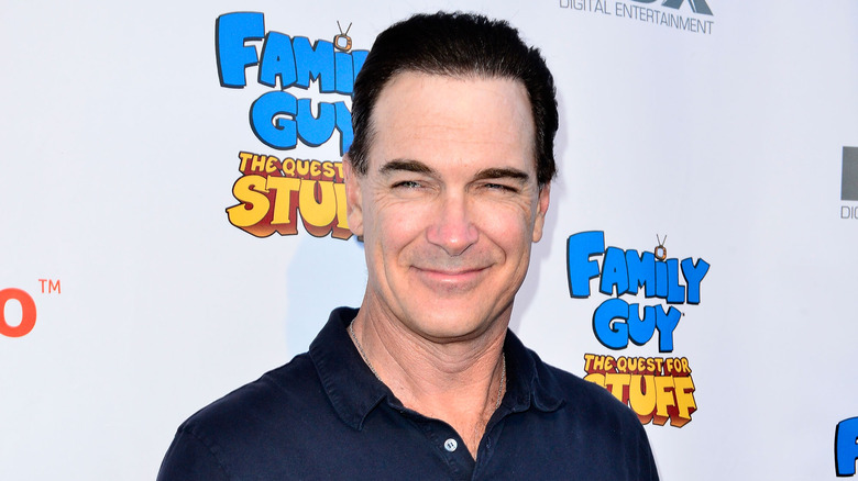 Patrick Warburton, smiling, no facial hair, blue shirt, promoting Family Guy video game in 2014 