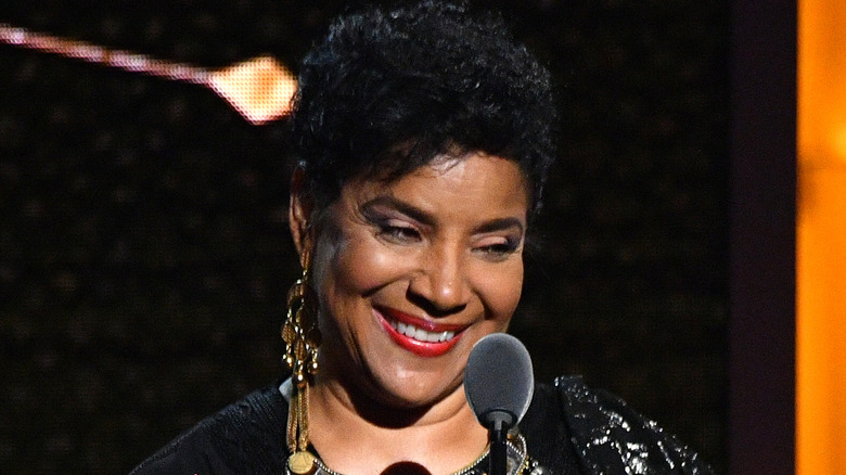 Phylicia Rashad standing in front of a microphone