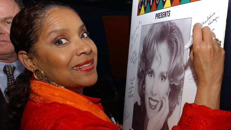 Phylicia Rashad signing a poster