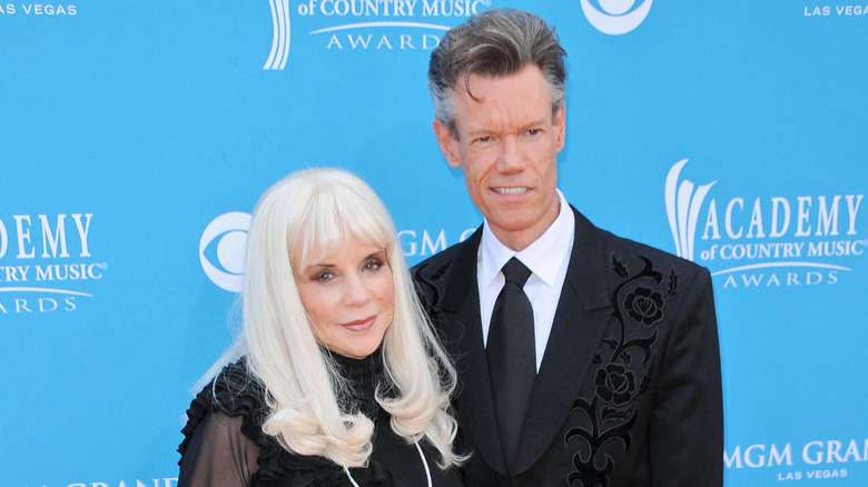 Elizabeth Hatcher-Travis and Randy Travis on the red carpet