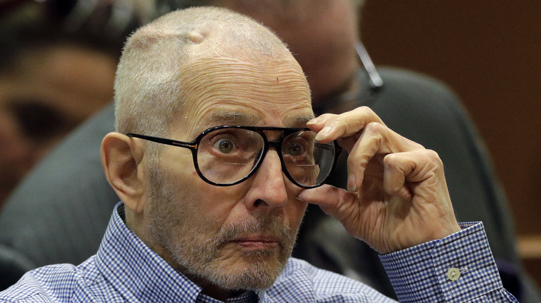 Robert Durst adjusting his glasses