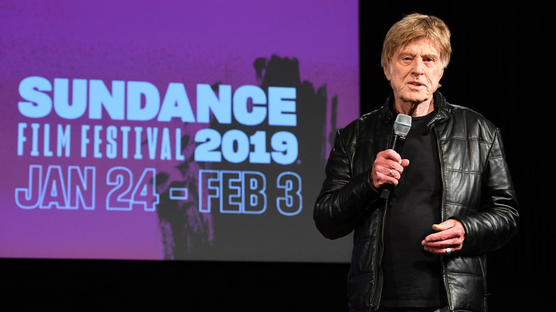 Robert Redford speaking beside Sundance Festival sign