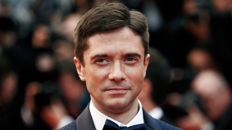 Topher Grace smiling slightly