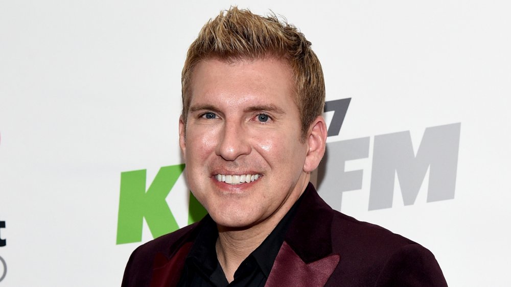 Todd Chrisley smiling and posing at an event
