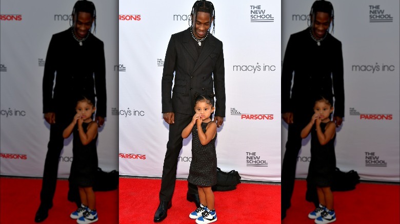 Travis Scott posing with daughter Stormi