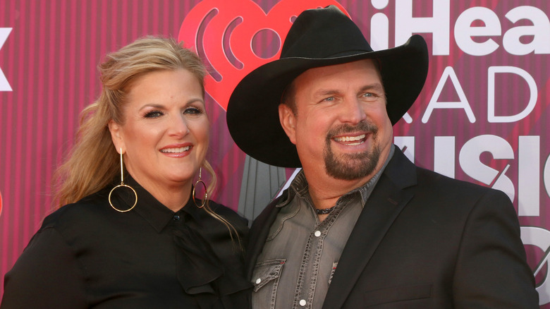 Trisha Yearwood and Garth Brooks, both smiling