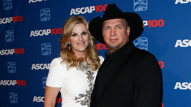 Trisha Yearwood and Garth Brooks, both smiling