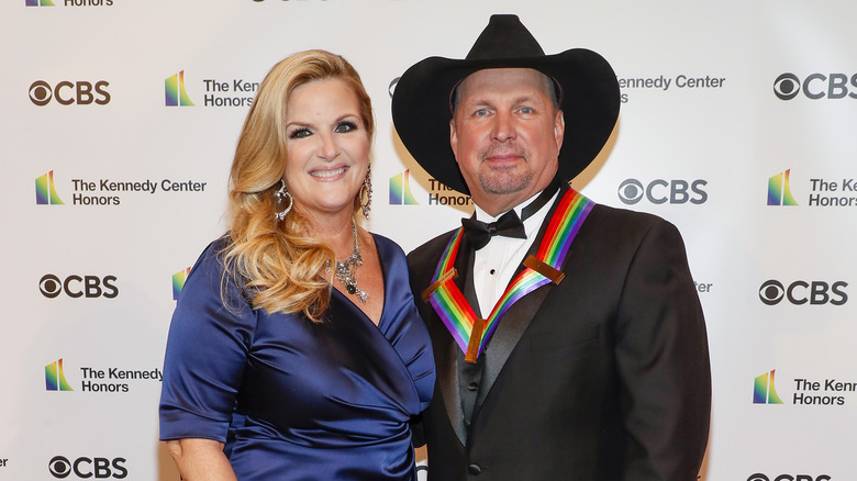 Trisha Yearwood and Garth Brooks, both smiling