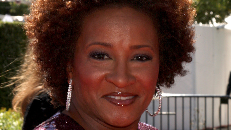 Wanda Sykes wearing hoop earrings, smiling