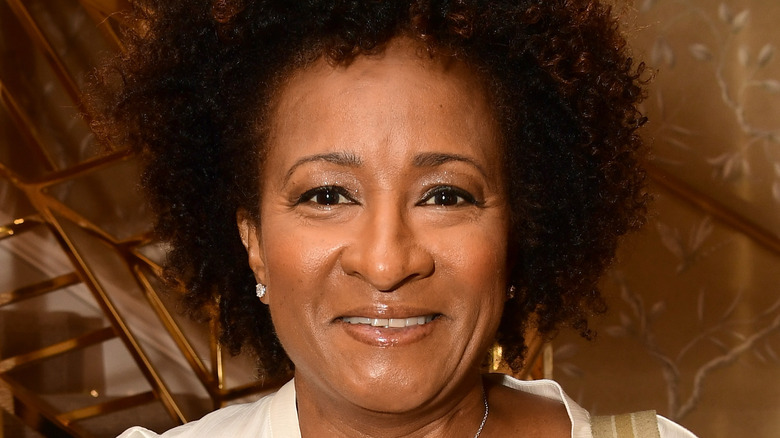 Wanda Sykes standing in front of a staircase, smiling