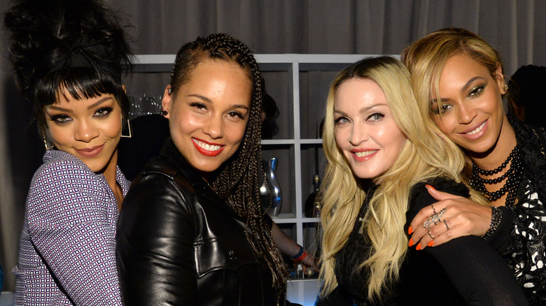 Rihanna posing with Alicia Keys, Madonna, and Beyoncé