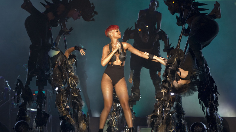 Rihanna on stage with backup dancers