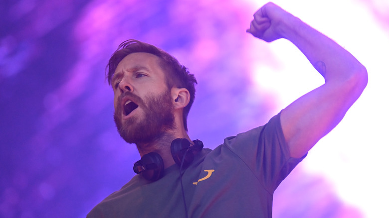 Calvin Harris fist pumping with his mouth open