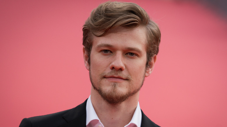 Lucas Till posing on a red carpet