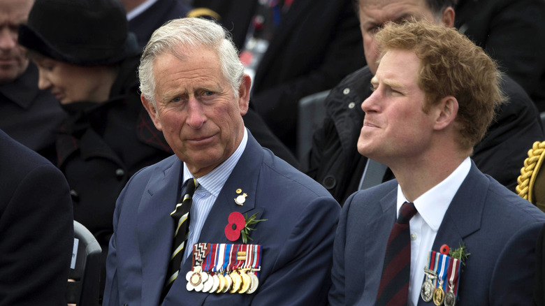 Prince Charles, looking annoyed, Prince Harry, looking confused, 2015 photo of them setting next to each other