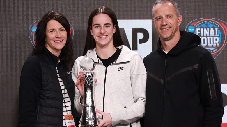 Caitlin Clark posing with her parents