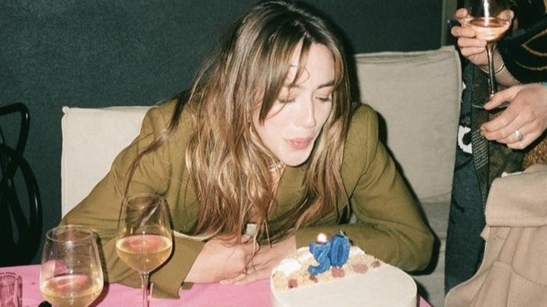 Chloe Bennet, blowing out a 30th birthday candle, 2022 photo 