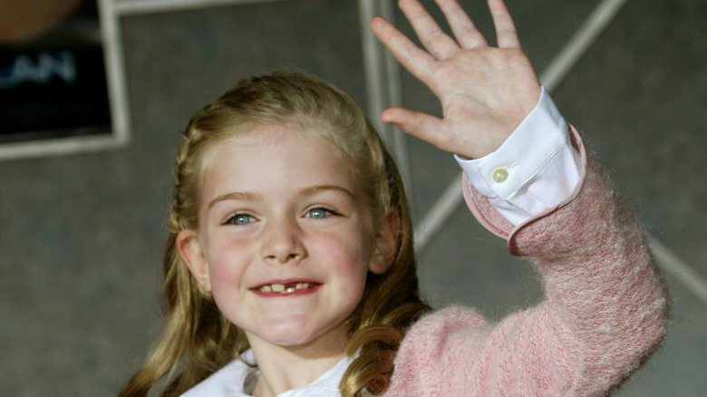 Marlene Lawston waving at a red carpet event