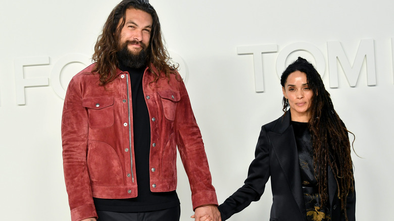 Jason Momoa and Lisa Bonet holding hands