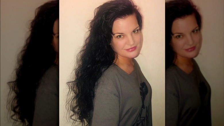 Pauley Perrette with long curly hair