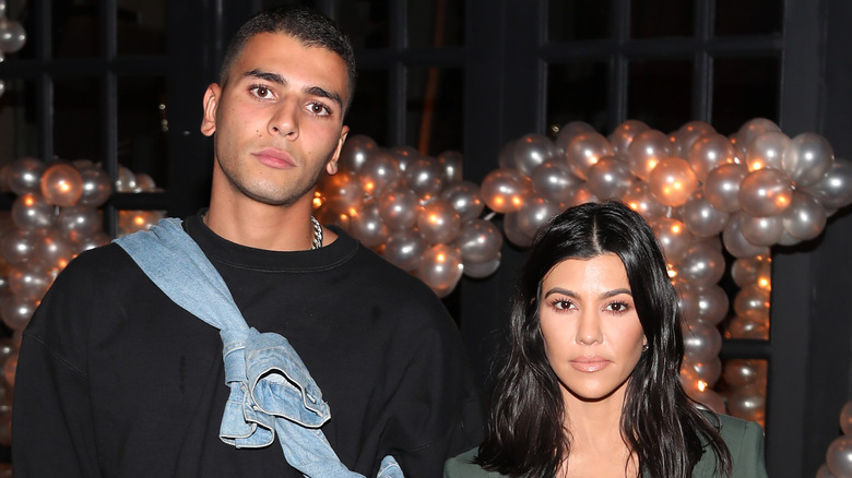 Younes Bendjima and Kourtney Kardashian posing