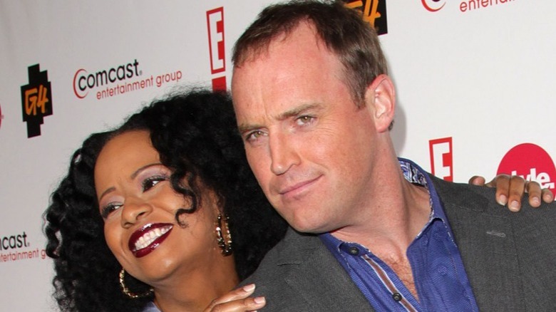 Tempestt Bledsoe and Matt Iseman posing on red carpet