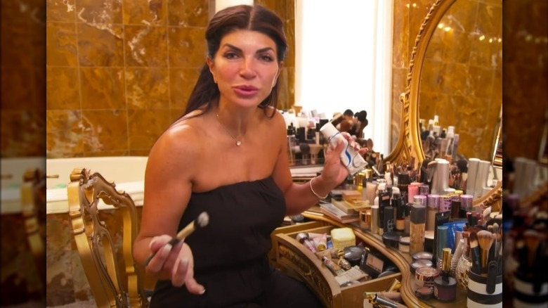 Teresa Giudice smiling seated at vanity