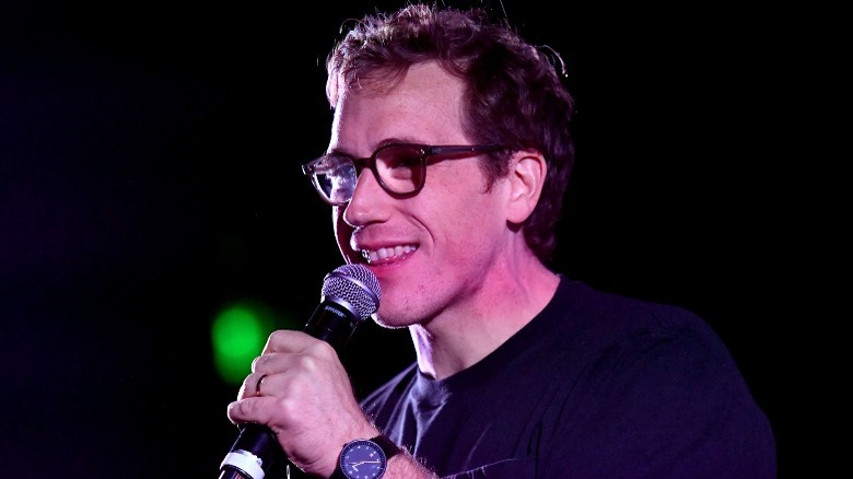 Conner O'Malley performing onstage, holding a mic