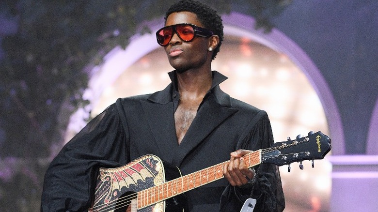 Alton Mason playing guitar at Cannes