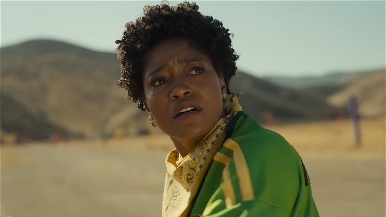 Keke Palmer in a green outfit looking scared