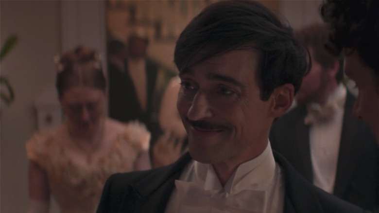 Blake Ritson as Oscar, smiling to the left