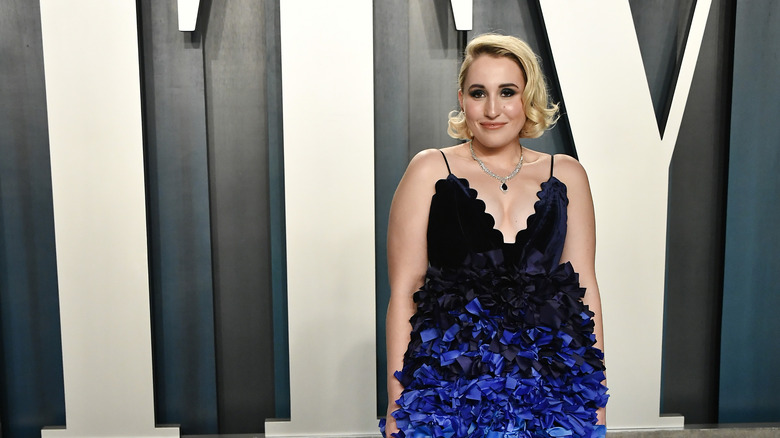 Harley Quinn Smith on red carpet, smiling