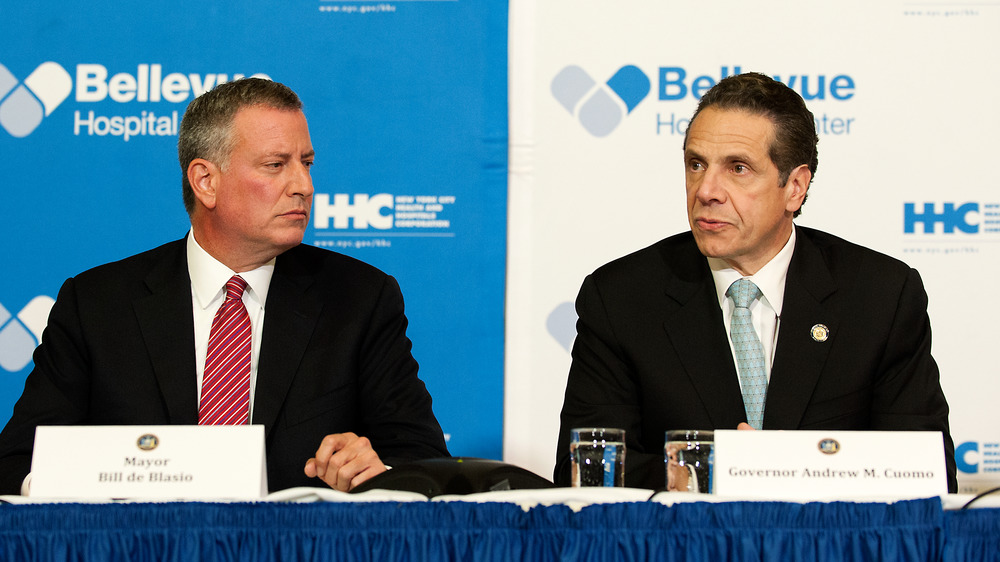 Bill de Blasio and Andrew Cuomo sitting at a table together