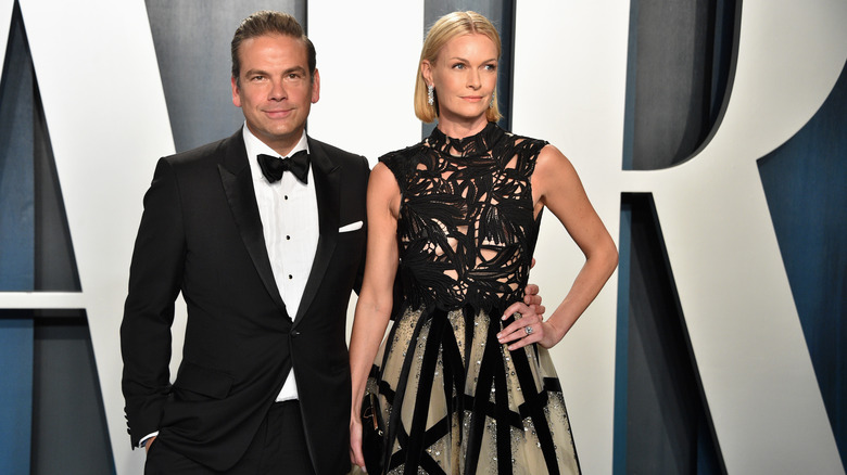 Lachlan and Sarah Murdoch standing at red carpet event