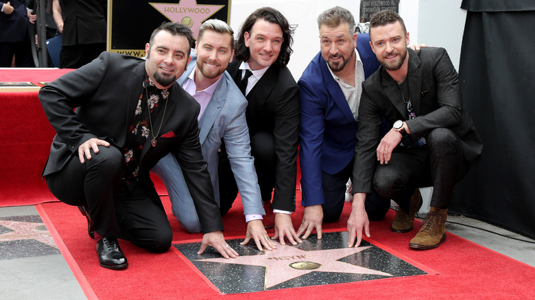 NSYNC posing with their star on the Hollywood Walk of Fame