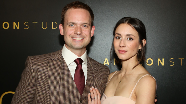 Patrick J. Adams and Troian Bellisario smiling