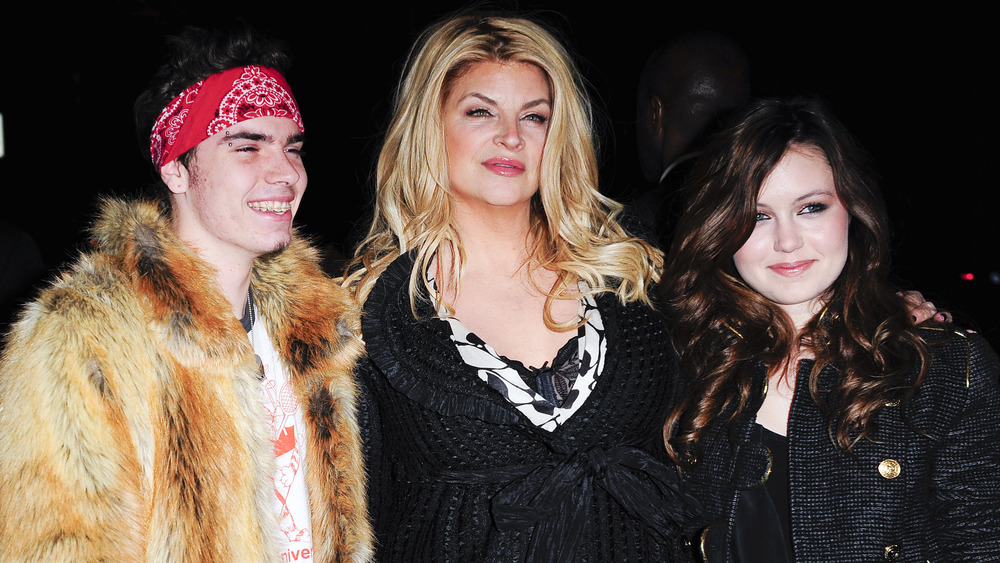 Kirstie Alley and children posing on the red carpet