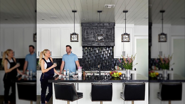 Heather Rae Young and Tarek El Moussa stand together in their giant kitchen