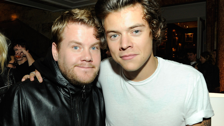 James Corden and Harry Styles smiling together  