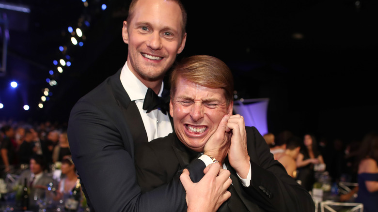 Jack McBrayer and Alexander Skarsgård hugging and laughing 