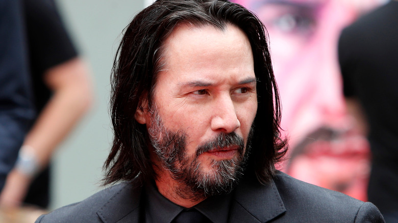 Keanu Reeves looking away