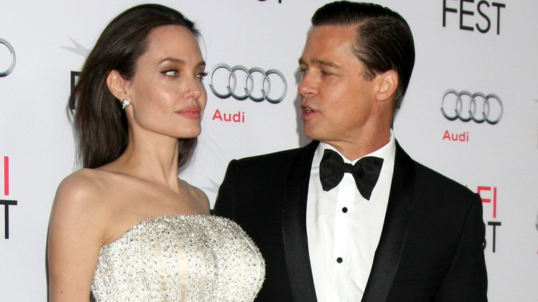 Angelina Jolie posing sternly with Brad Pitt